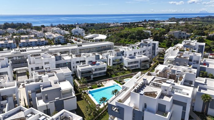 Appartement élégant de 2 chambres sur la Nouvelle Milla d'Or, avec terrasse, vues sur la montagne et commodités de luxe.